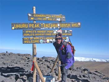 Made it. Haggard Kwameh next to the famous signboard at Uhuru Peak Kilimanjaro! 